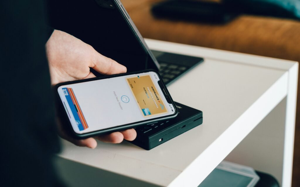 Person Tapping their credit card to pay off debt