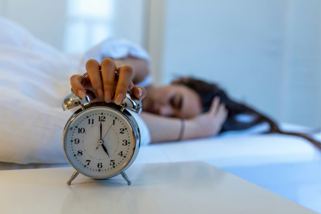 Image showing a woman stopping an alarm clock - waking up to APR costs