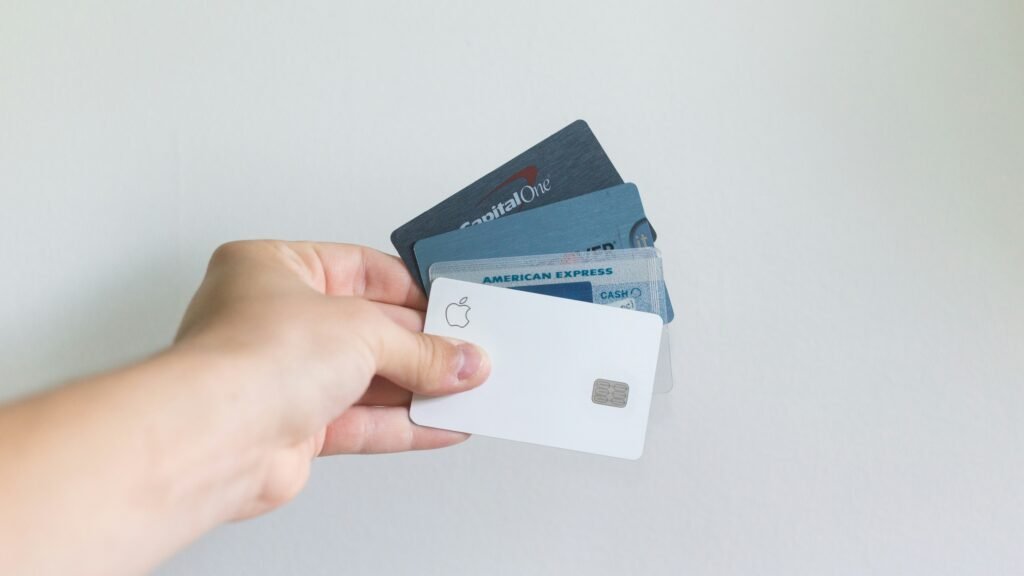 Man holding 5 credit cards